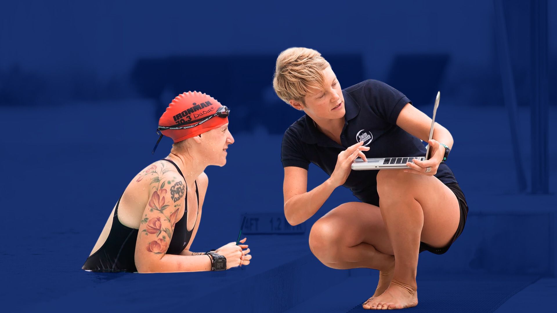 Swim Smooth coach reviewing video analysis with a swimmer at the poolside